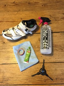 How and When To Replace Road Bike Cleats - A photo of hex keys, grease, electrical tape, water spray and road bike shoes