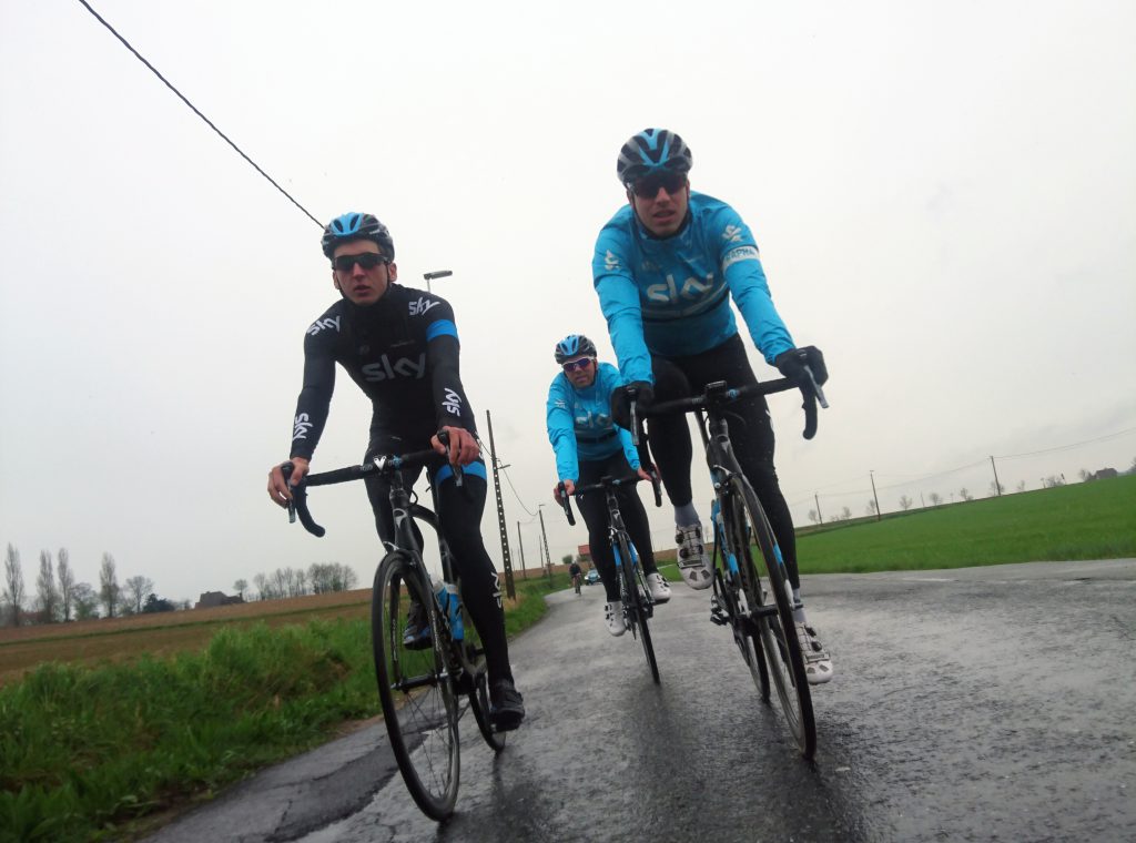 Winter miles, summer smiles. Cyclists on a wet road. 