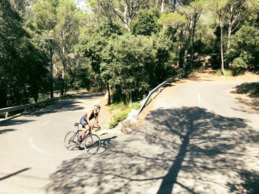 Viva Velo - a cyclist rides uphill in sunshine