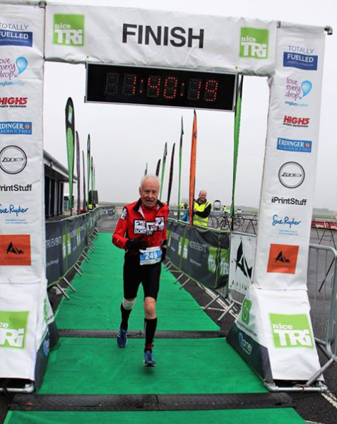 Maurice crossing the finish line triathlon racing after retirement
