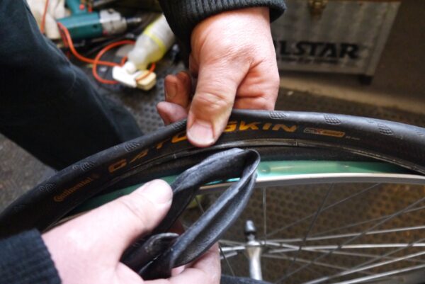 bicycle inner tube Inserting the new tube, valve first.