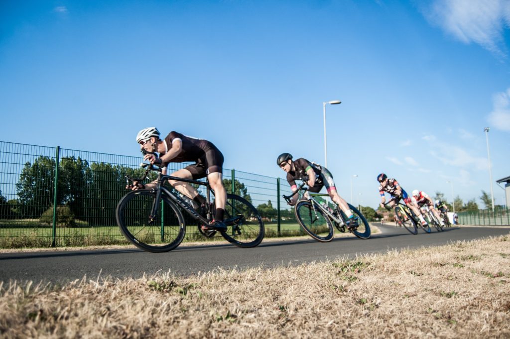 A group of men cycling behind one another