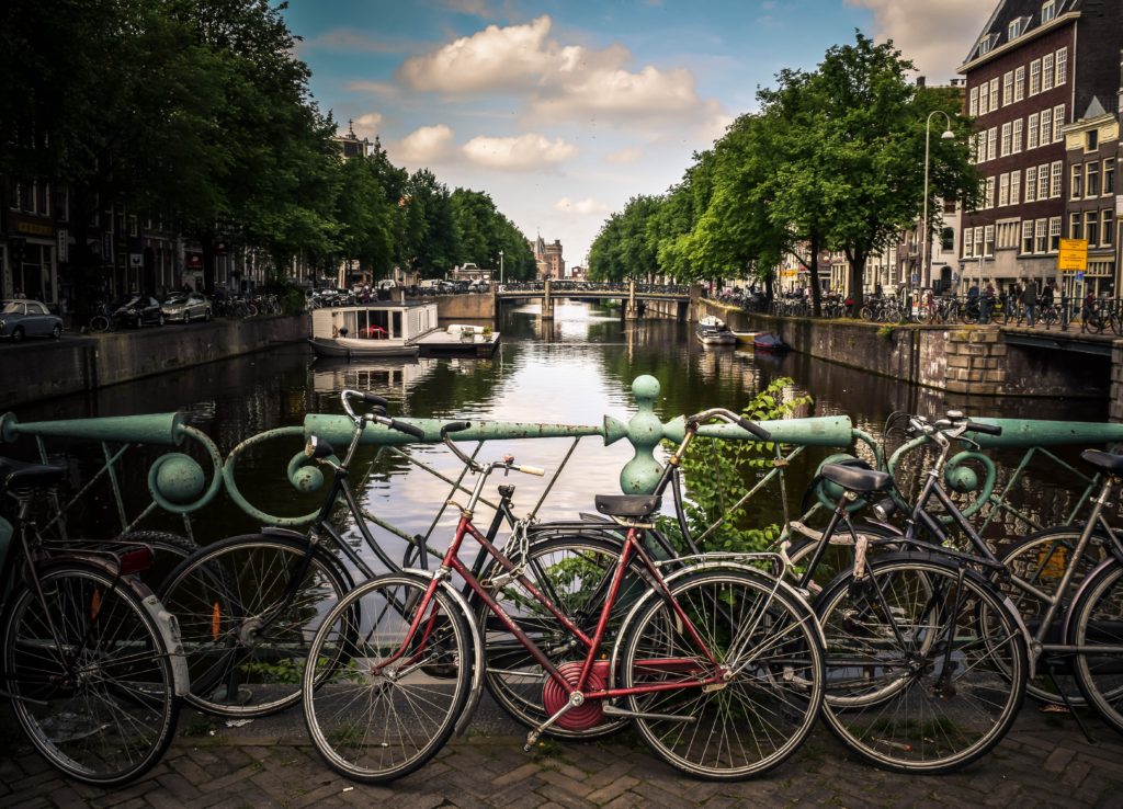 Cycling commuter kit list, tips for cycling to work, bicycles parked by the canal in Amsterdam