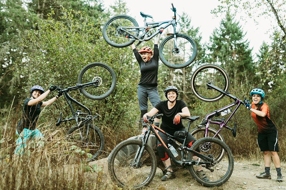 A group of friends have fun riding beautiful mountain bike paths and trails in the Pacific Northwest. Women mountain biking group