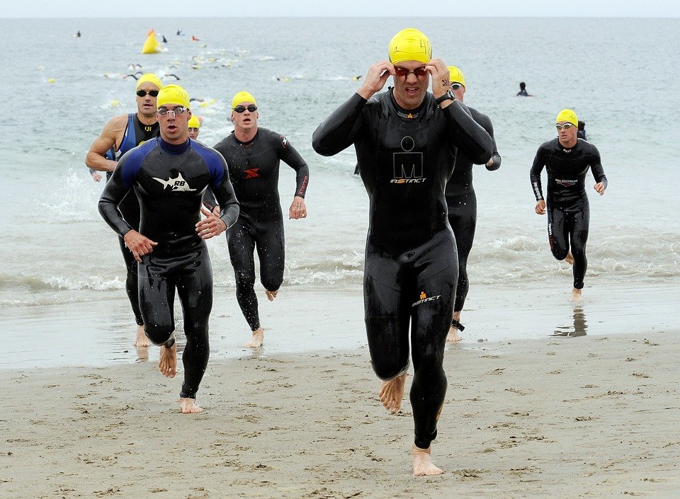 Triathlons - Swimmers run out of the water