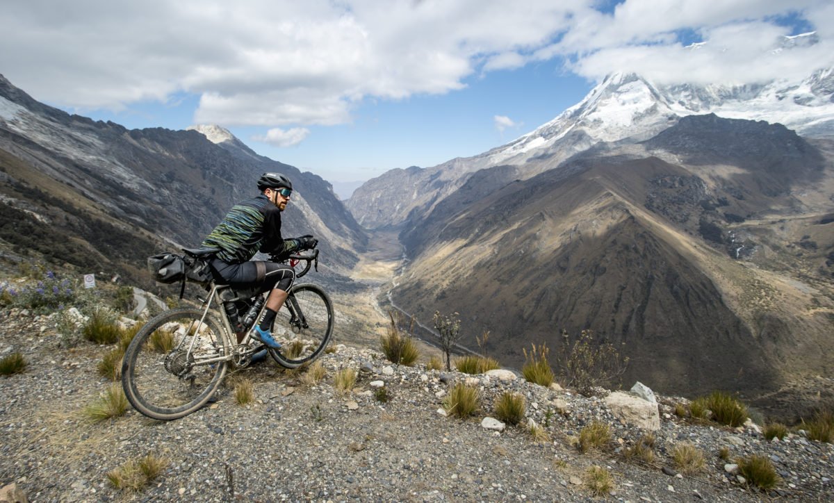 Cycling in Peru - Adventure Bike Rider looks out on the Andes Mountain Range 