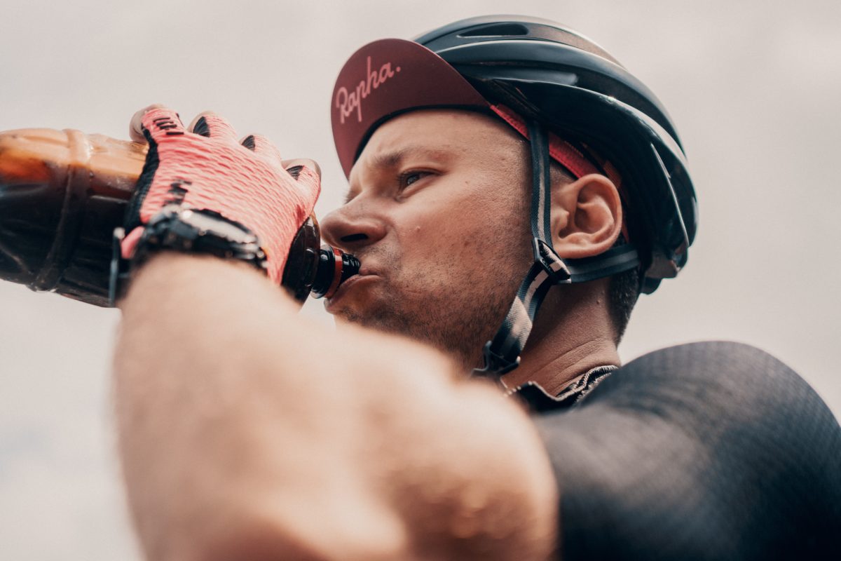 A cyclist drinking mid ride - ketone supplement 