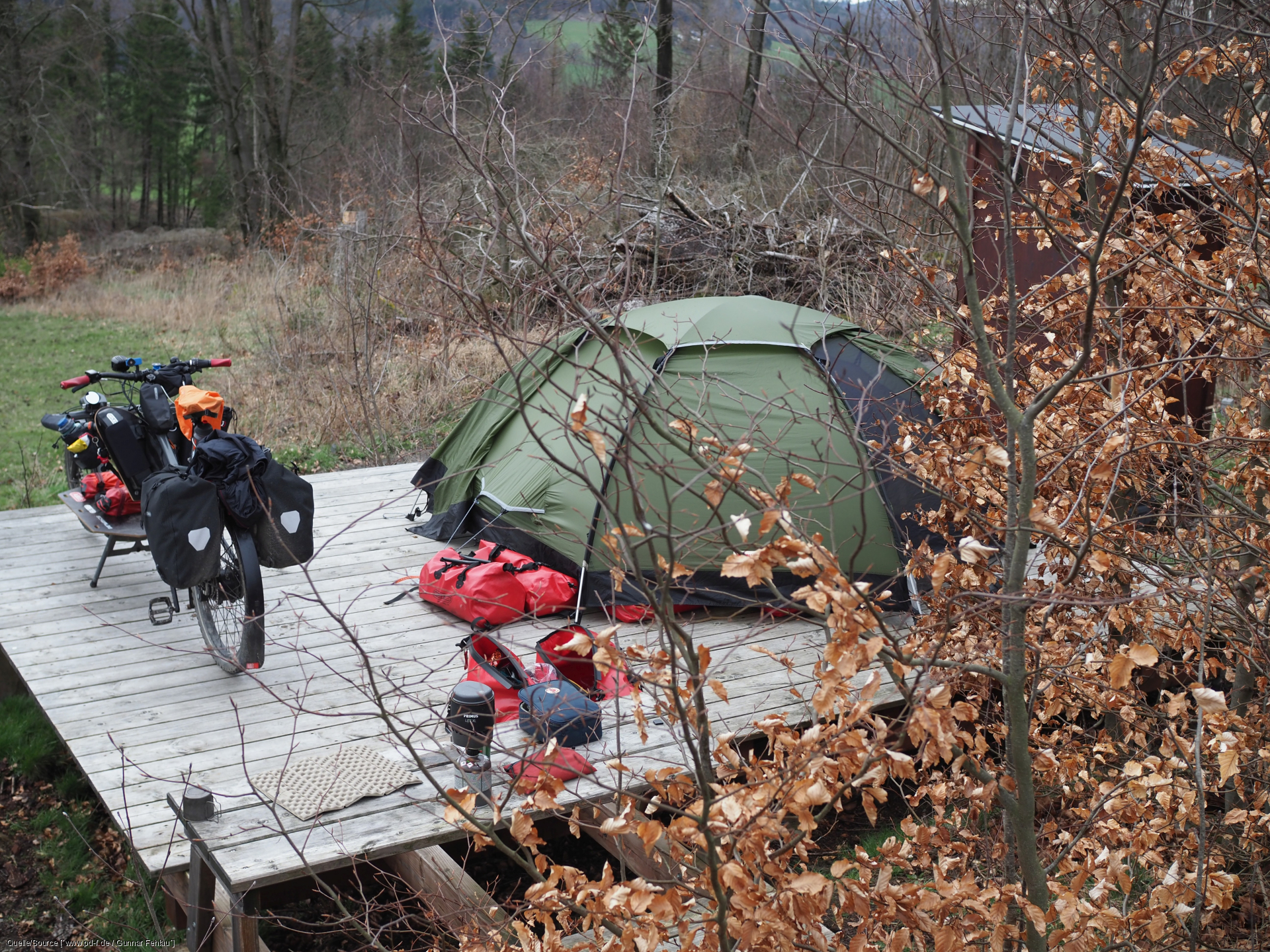 cargo bike parked alongside erected tent 