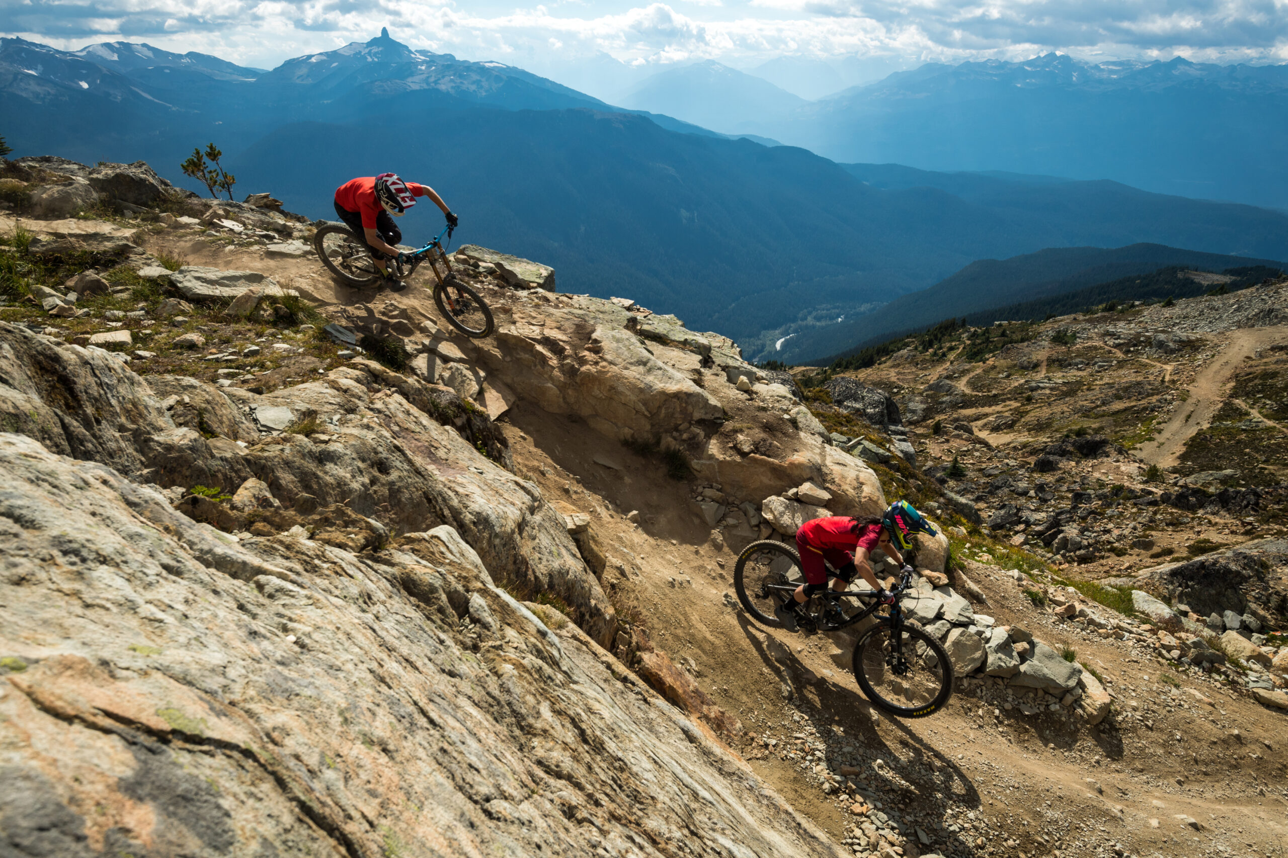 Mountain bikers riding over rocks in Whistler bike park