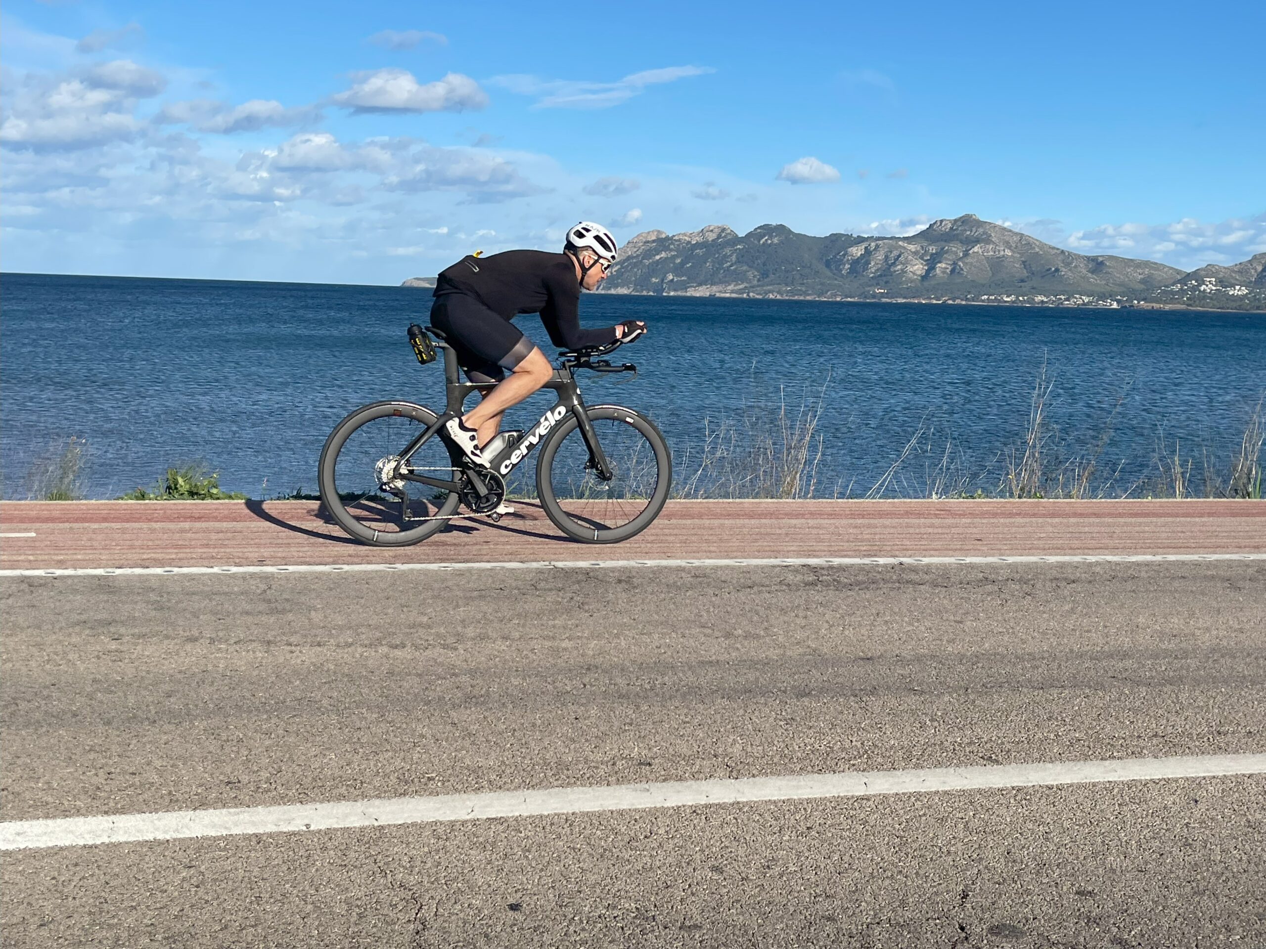 Triathlete riding along Mallorca seafront