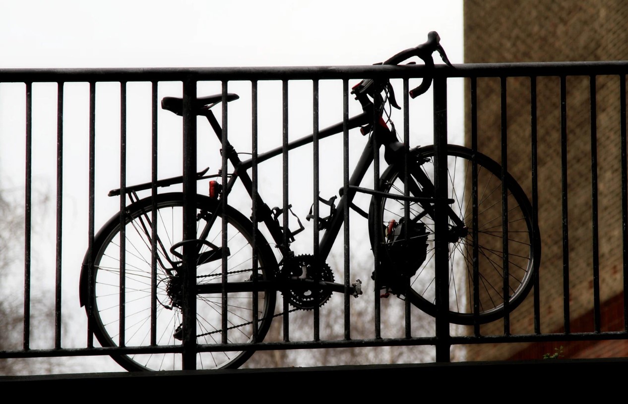 a bicycle locked to railings outside a persons flat